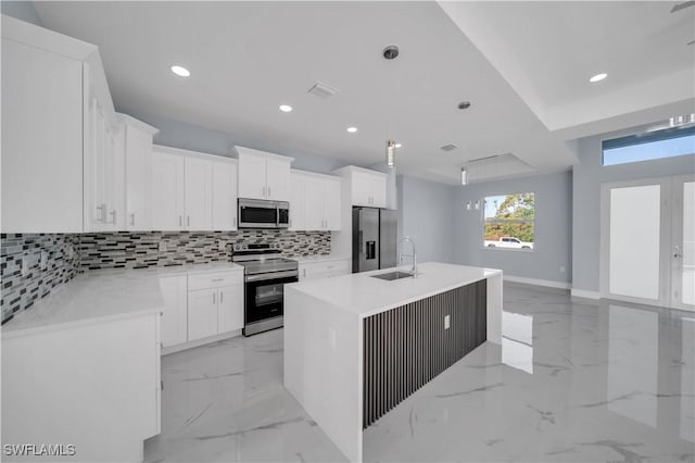 kitchen featuring tasteful backsplash, recessed lighting, marble finish floor, a sink, and stainless steel appliances