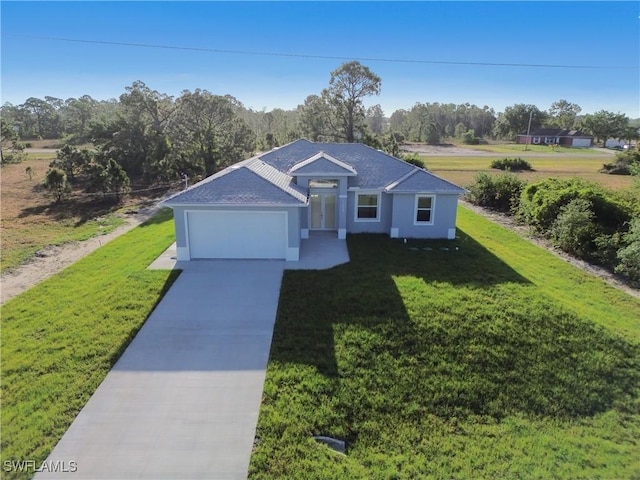 view of front of home featuring an attached garage, concrete driveway, and a front lawn