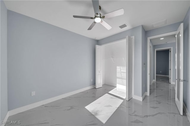 unfurnished bedroom with ceiling fan, a closet, visible vents, marble finish floor, and baseboards