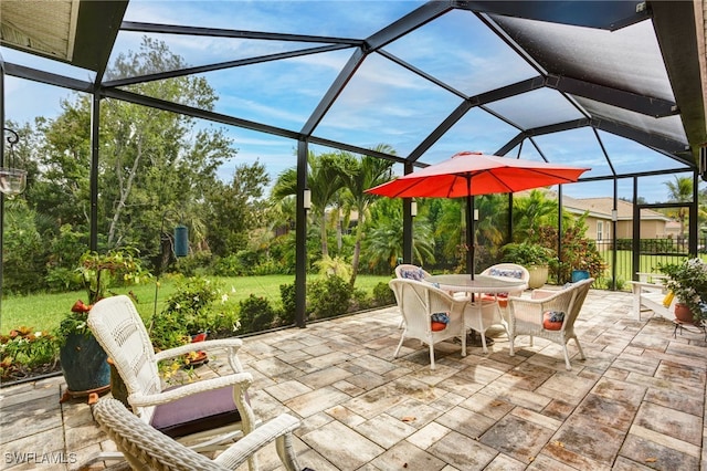 view of patio featuring glass enclosure