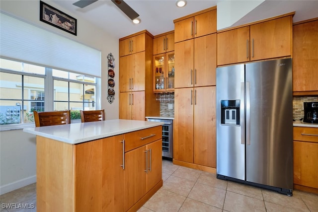 20211 Burnside Pl Unit 203, Estero, FL 33928 - kitchen with a healthy amount of sunlight, beverage cooler, tasteful backsplash, and stainless steel fridge
