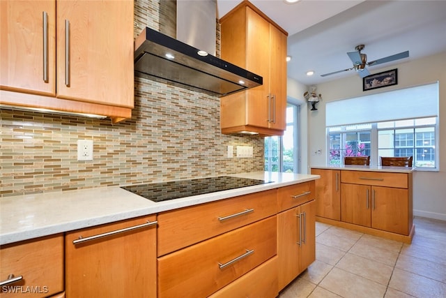 20211 Burnside Pl Unit 203, Estero, FL 33928 - kitchen with tasteful backsplash, light tile patterned flooring, ceiling fan, black electric stovetop, and wall chimney exhaust hood