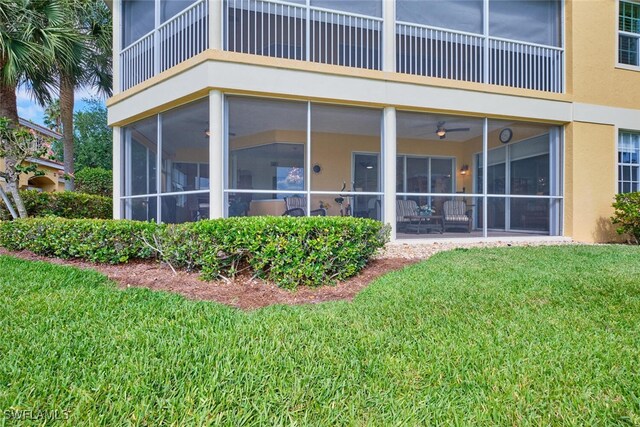 20211 Burnside Pl Unit 203, Estero, FL 33928 - rear view of house with a lawn, a sunroom, a balcony, and stucco siding