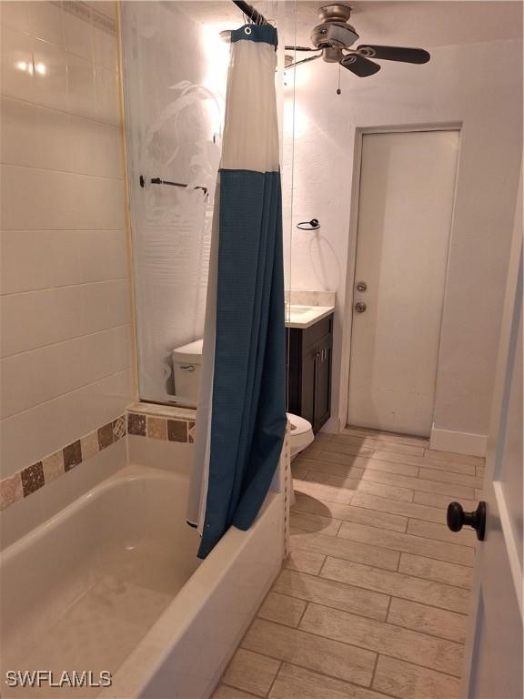 bathroom with vanity, ceiling fan, and shower / tub combo with curtain