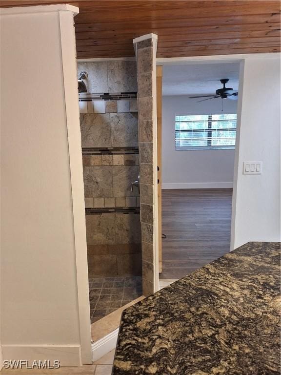 unfurnished bedroom with baseboards, wooden ceiling, and wood finished floors