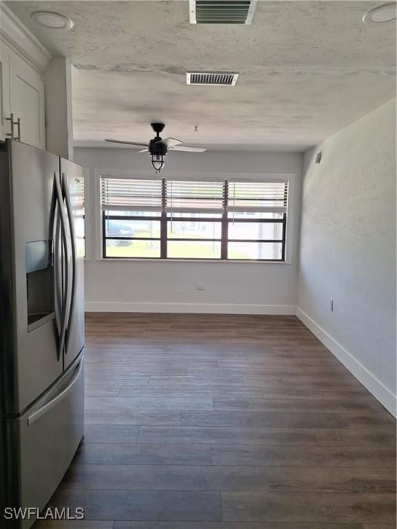 kitchen with visible vents, baseboards, stainless steel fridge, and ceiling fan