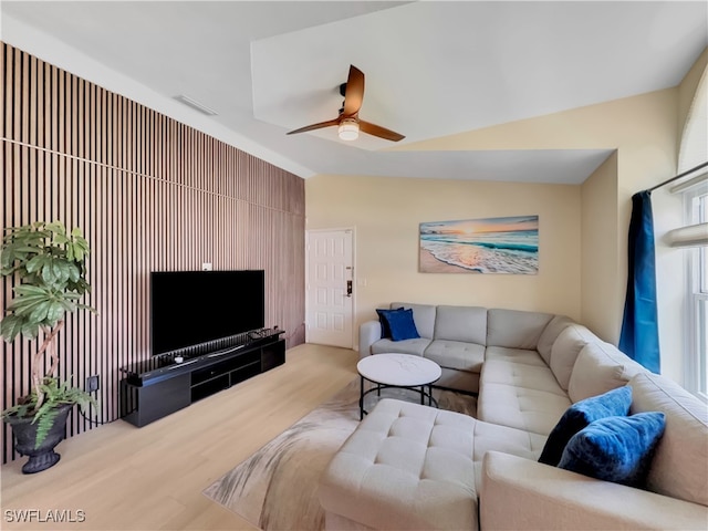 living area with visible vents, ceiling fan, wood finished floors, and lofted ceiling