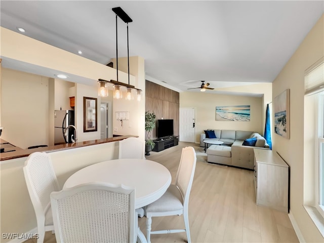 dining space featuring light wood-style flooring and ceiling fan