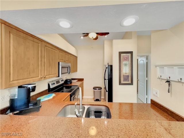 kitchen with a sink, a ceiling fan, and stainless steel appliances