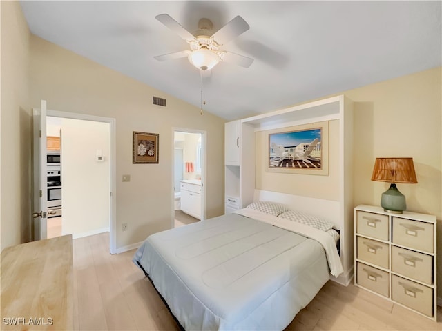 bedroom with baseboards, vaulted ceiling, connected bathroom, light wood-style floors, and visible vents