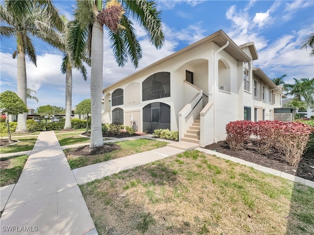 view of front of house featuring a front yard and stucco siding