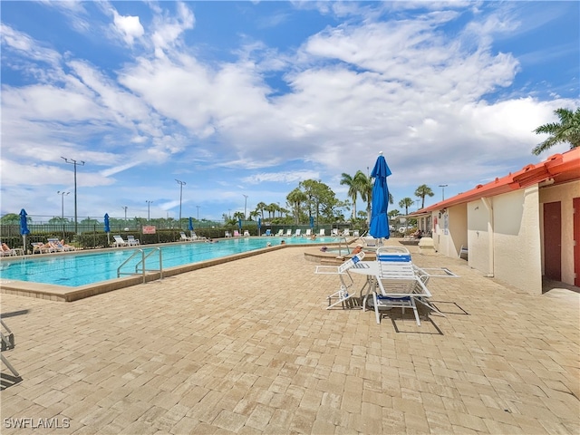 pool featuring a patio area and fence