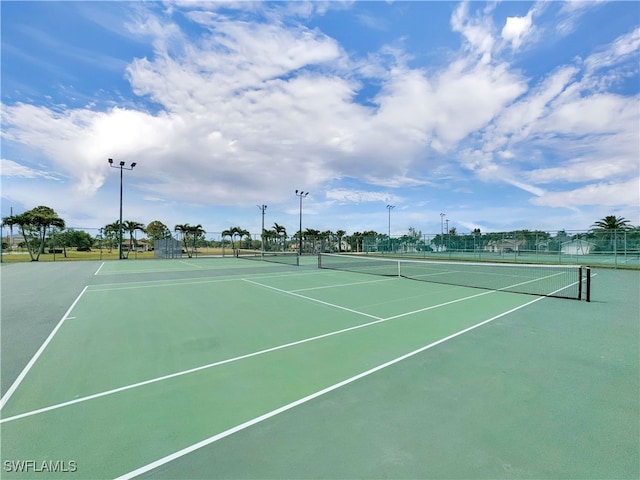 view of tennis court featuring fence