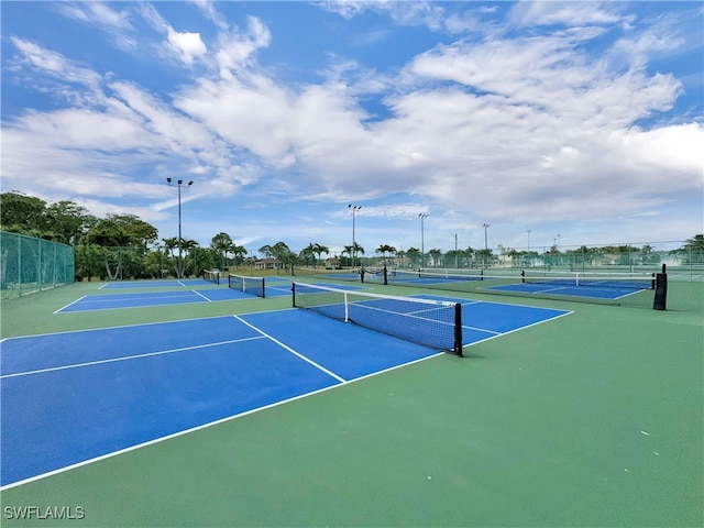 view of tennis court featuring fence