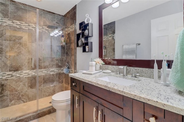 2420 6th Ave SE, Naples, FL 34117 - bathroom featuring toilet, vanity, and a stall shower