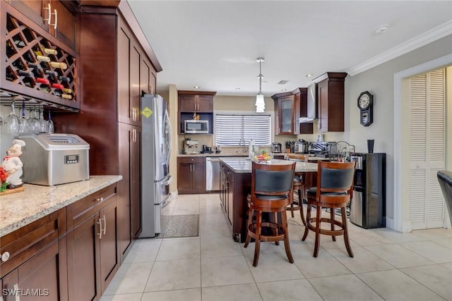 2420 6th Ave SE, Naples, FL 34117 - kitchen with stainless steel appliances, light tile patterned floors, a kitchen breakfast bar, and ornamental molding