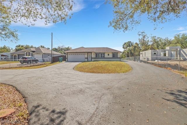 2420 6th Ave SE, Naples, FL 34117 - single story home featuring fence, a residential view, a garage, and aphalt driveway