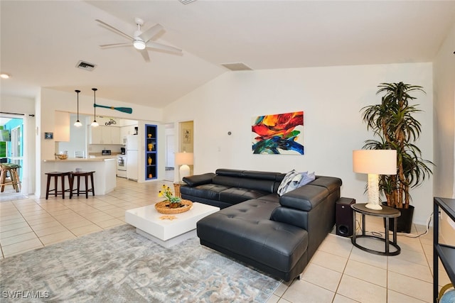 living area with lofted ceiling, a ceiling fan, visible vents, and light tile patterned floors