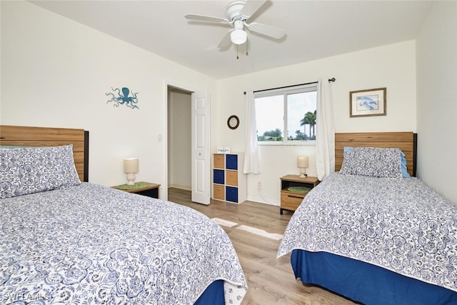 bedroom with ceiling fan, baseboards, and light wood-type flooring