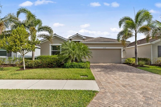 16148 Bonita Landing Cir, Bonita Springs, FL 34135 - single story home with a garage, stucco siding, a front lawn, and decorative driveway