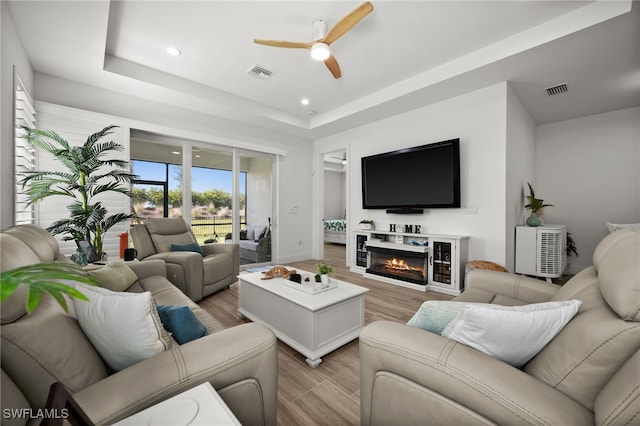 44372 Panther Dr, Punta Gorda, FL 33982 - living room featuring visible vents, a raised ceiling, ceiling fan, recessed lighting, and light wood-style flooring