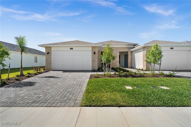 44372 Panther Dr, Punta Gorda, FL 33982 - view of front of home with brick siding, a front lawn, decorative driveway, and a garage