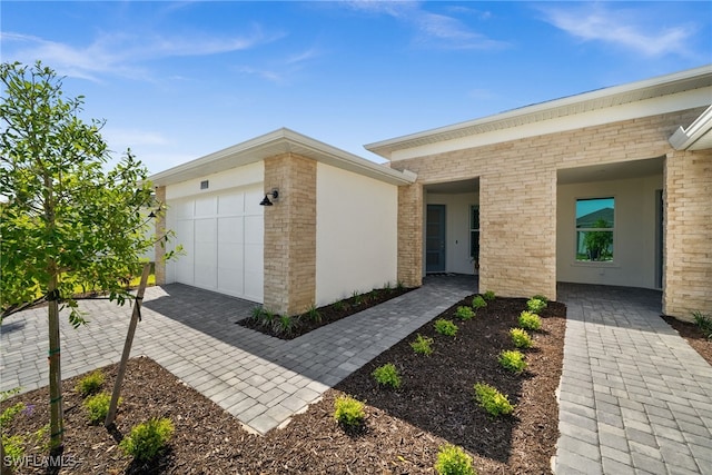 44372 Panther Dr, Punta Gorda, FL 33982 - doorway to property featuring a garage and brick siding