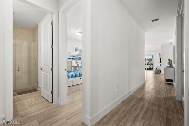 44372 Panther Dr, Punta Gorda, FL 33982 - hallway with visible vents, baseboards, and wood tiled floor