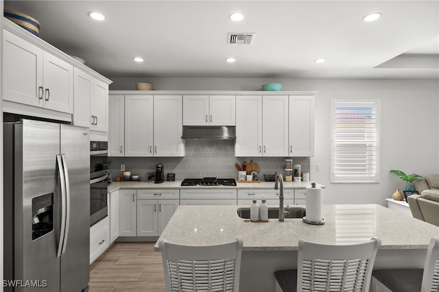 44372 Panther Dr, Punta Gorda, FL 33982 - kitchen featuring visible vents, recessed lighting, appliances with stainless steel finishes, under cabinet range hood, and a sink