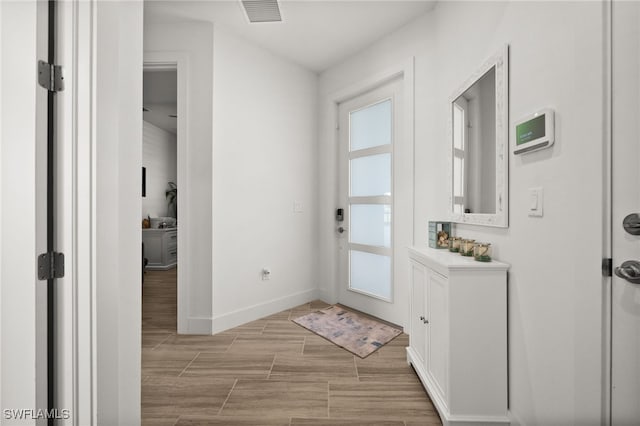 44372 Panther Dr, Punta Gorda, FL 33982 - doorway to outside with visible vents, baseboards, and wood tiled floor