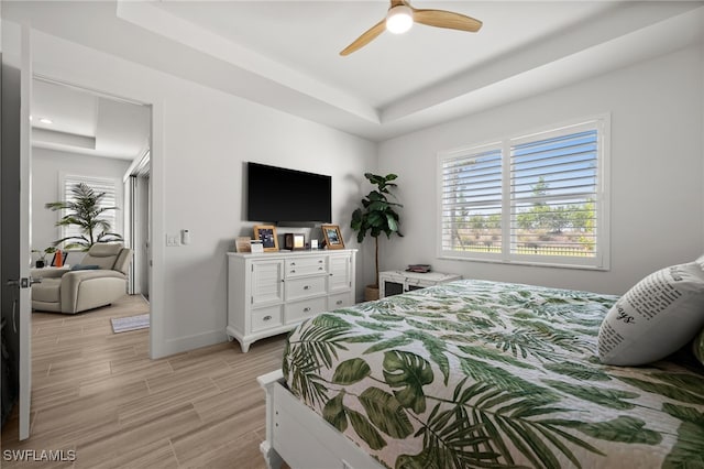 44372 Panther Dr, Punta Gorda, FL 33982 - bedroom featuring light wood-style flooring, multiple windows, baseboards, and a raised ceiling