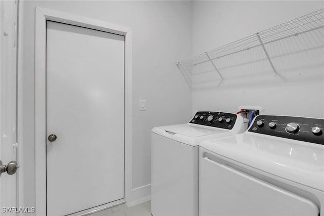 435 Pickford Ave, Lehigh Acres, FL 33974 - clothes washing area featuring separate washer and dryer, light marble finish flooring, and baseboards