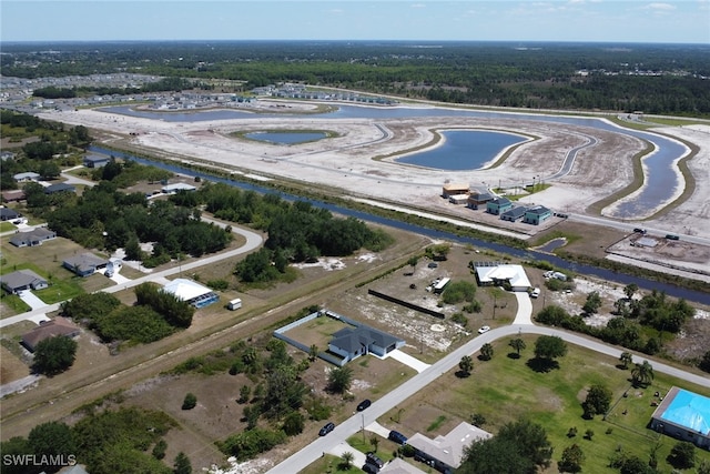 435 Pickford Ave, Lehigh Acres, FL 33974 - aerial overview of property's location featuring a large body of water and a heavily wooded area