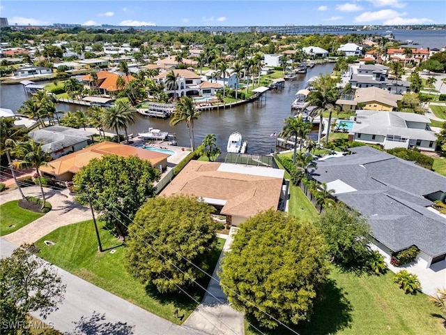 drone / aerial view with a residential view and a water view