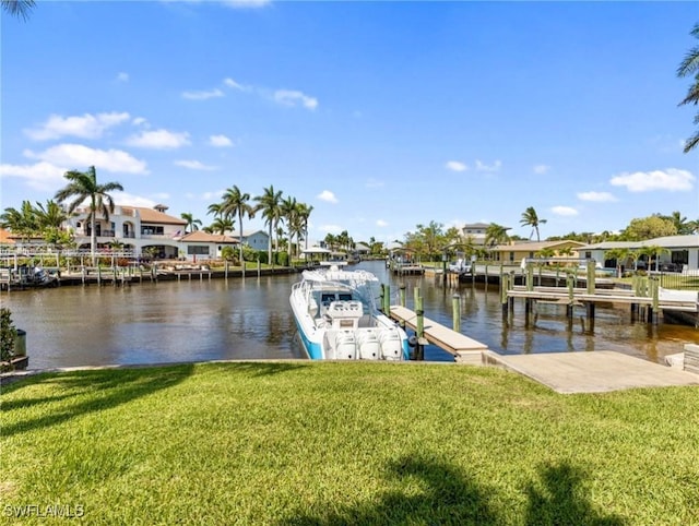 dock area with a yard, a residential view, and a water view