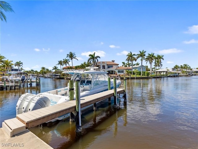 dock area with boat lift and a water view
