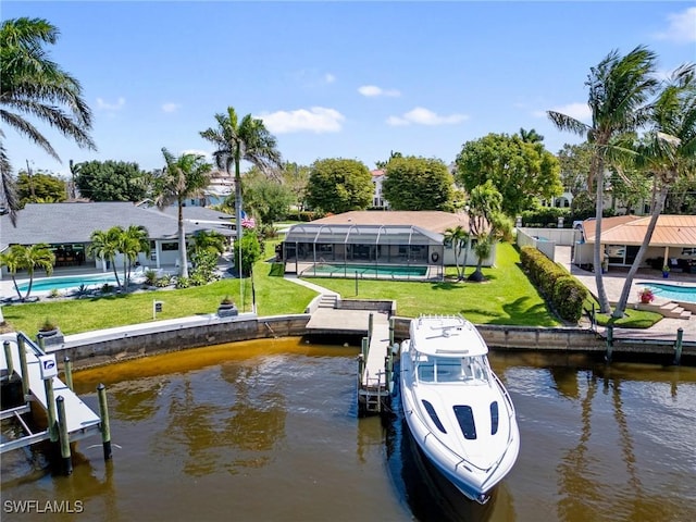 view of dock with a water view, a yard, and boat lift