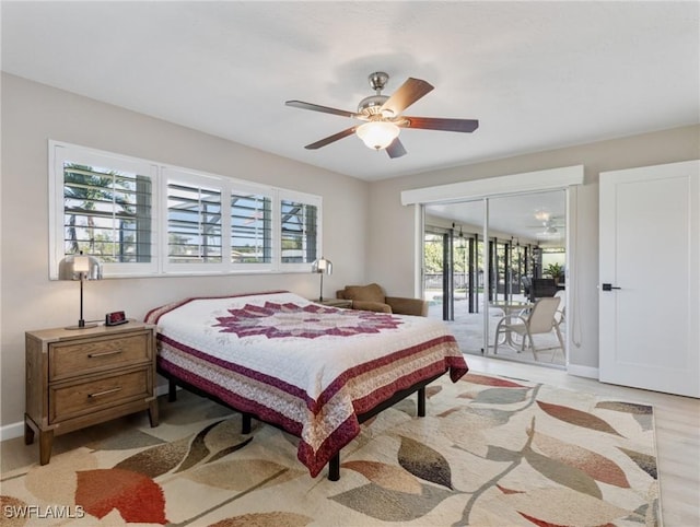 bedroom featuring access to exterior, light wood-style flooring, multiple windows, and baseboards