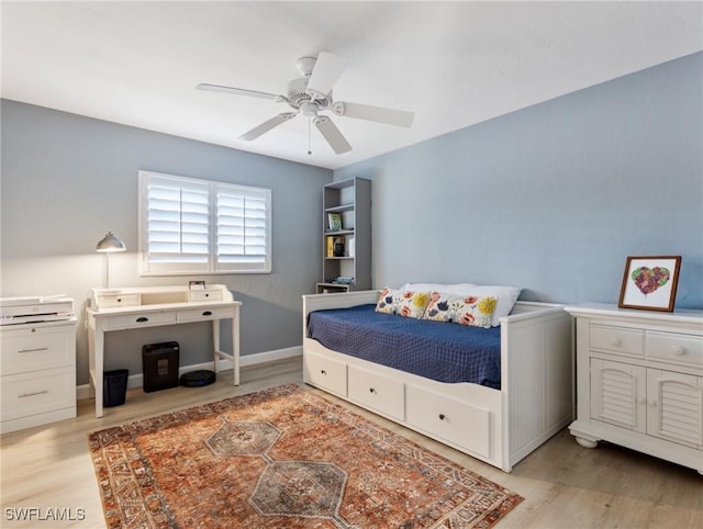 bedroom with baseboards, light wood-type flooring, and a ceiling fan
