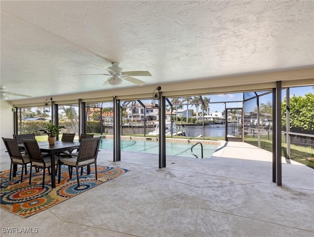 view of swimming pool with a patio area, ceiling fan, a fenced in pool, and a lanai