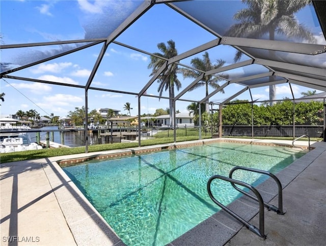 pool with a water view, a patio, glass enclosure, and a dock