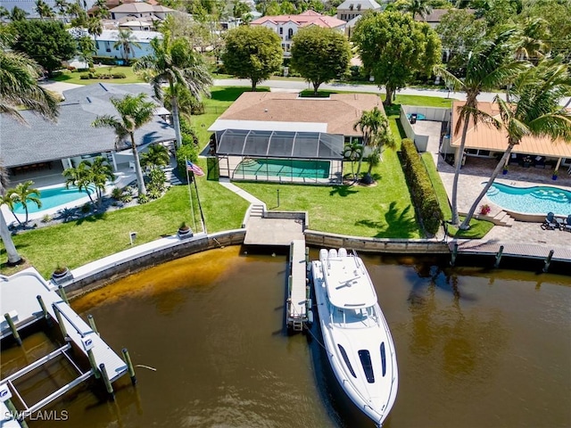 drone / aerial view featuring a residential view and a water view