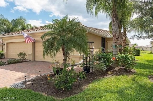 2035 Wellington St, Naples, FL 34120 - exterior space with a tiled roof, an attached garage, stucco siding, a front lawn, and decorative driveway