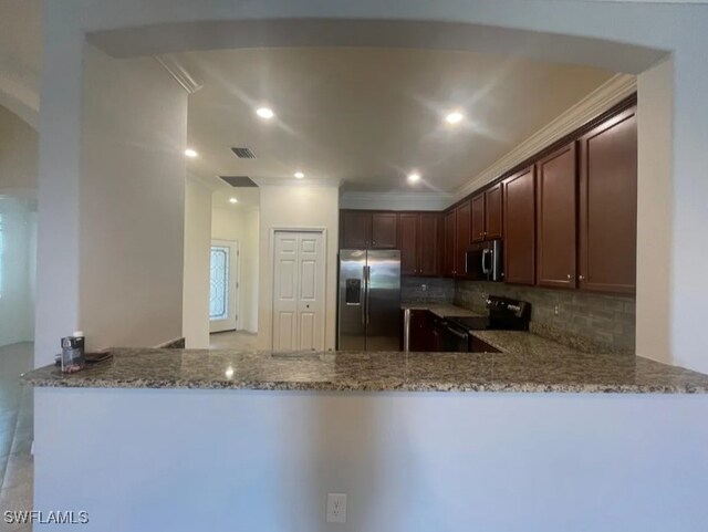 2035 Wellington St, Naples, FL 34120 - kitchen featuring light stone countertops, decorative backsplash, a peninsula, and stainless steel appliances