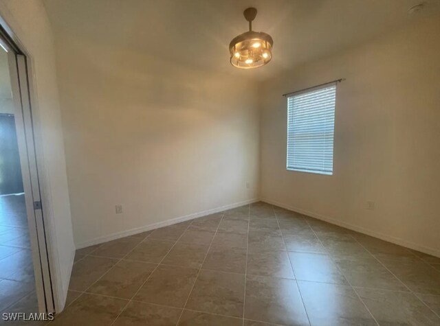 2035 Wellington St, Naples, FL 34120 - tiled spare room with baseboards