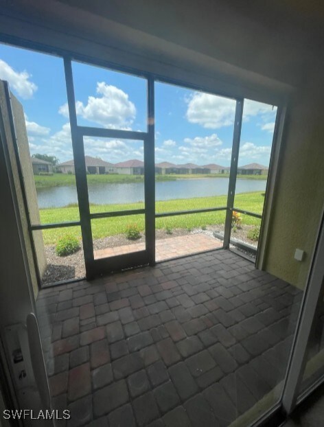 2035 Wellington St, Naples, FL 34120 - unfurnished sunroom featuring a water view