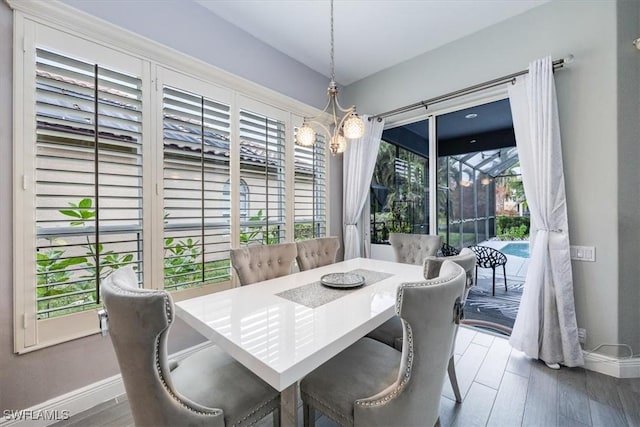 dining room featuring wood finished floors and baseboards