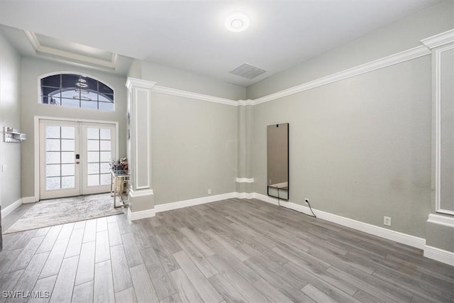 entrance foyer with french doors, visible vents, baseboards, and wood finished floors