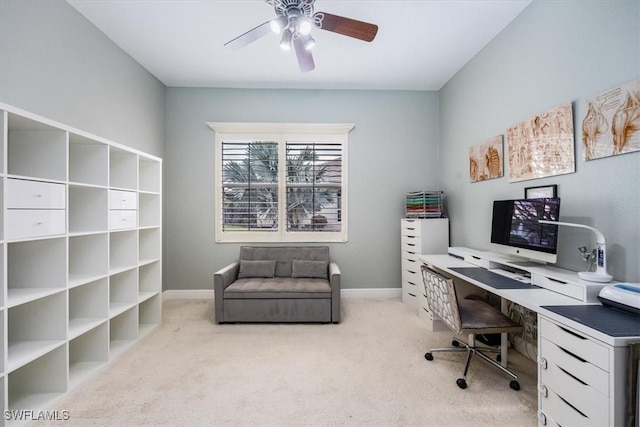 office space with ceiling fan, light colored carpet, and baseboards