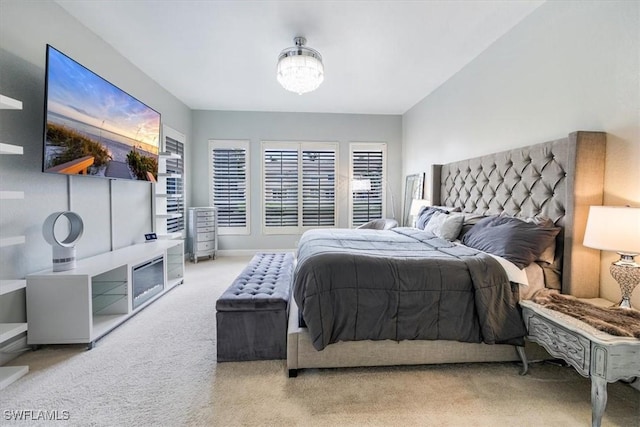 bedroom with carpet floors and a notable chandelier